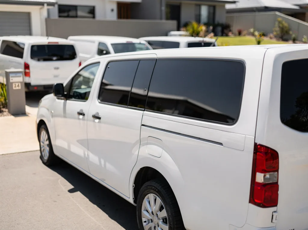 White commercial van with flawless dark tinted windows parked in Perth.