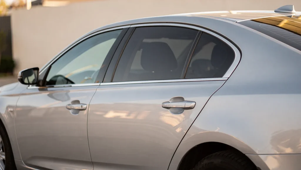 Freshly tinted car side window showing legal darkness level at a Perth home.